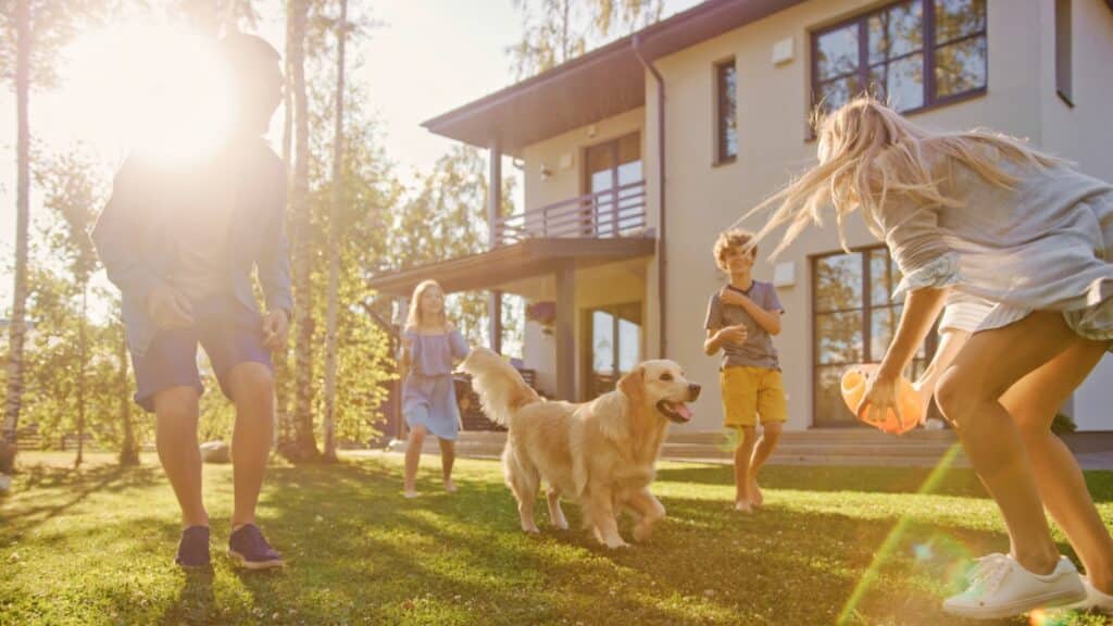 Family playing outdoors with their dog in a clean and comfortable home environment.